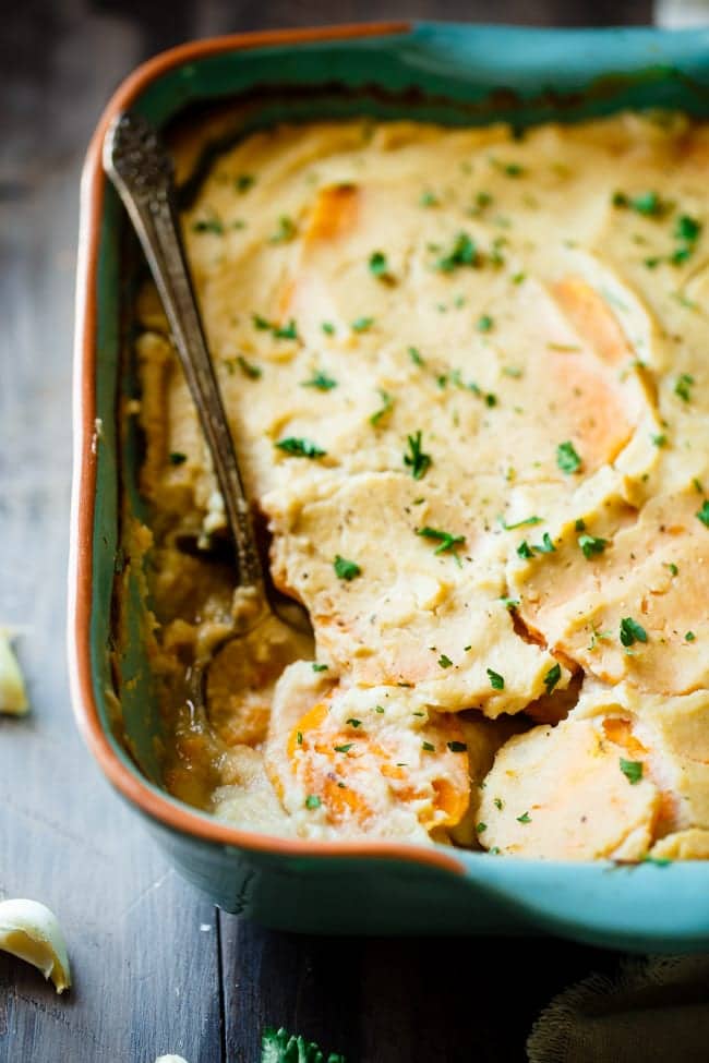 Cauliflower Alfredo Vegan Scalloped Sweet Potatoes - This whole30 compliant side dish is so creamy you'll never know they're under 200 calories, paleo friendly and have hidden veggies! Perfect for Thanksgiving! | Foodfaithfitness.com | @FoodFaithFit