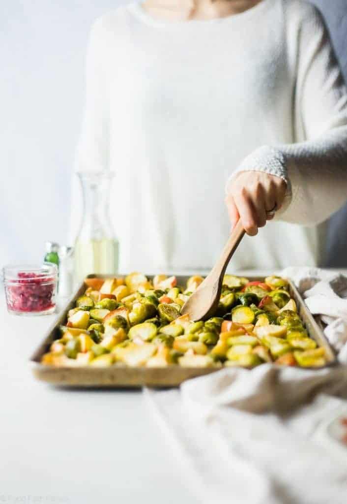 Superfood Roasted Brussels Sprouts with Bacon - These salty-sweet roasted Brussels sprouts are tender, crispy and have a surprise superfood pomegranate crunch! They're the perfect, paleo-friendly healthy Thanksgiving side! | Foodfaithfitness.com | @FoodFaithFit