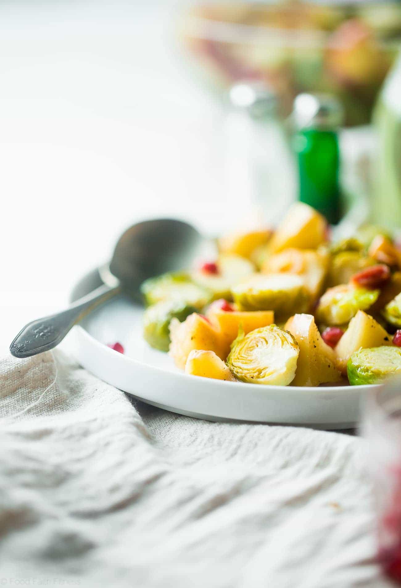 Superfood Roasted Brussels Sprouts with Bacon - These salty-sweet roasted Brussels sprouts are tender, crispy and have a surprise superfood pomegranate crunch! They're the perfect, paleo-friendly healthy Thanksgiving side! | Foodfaithfitness.com | @FoodFaithFit