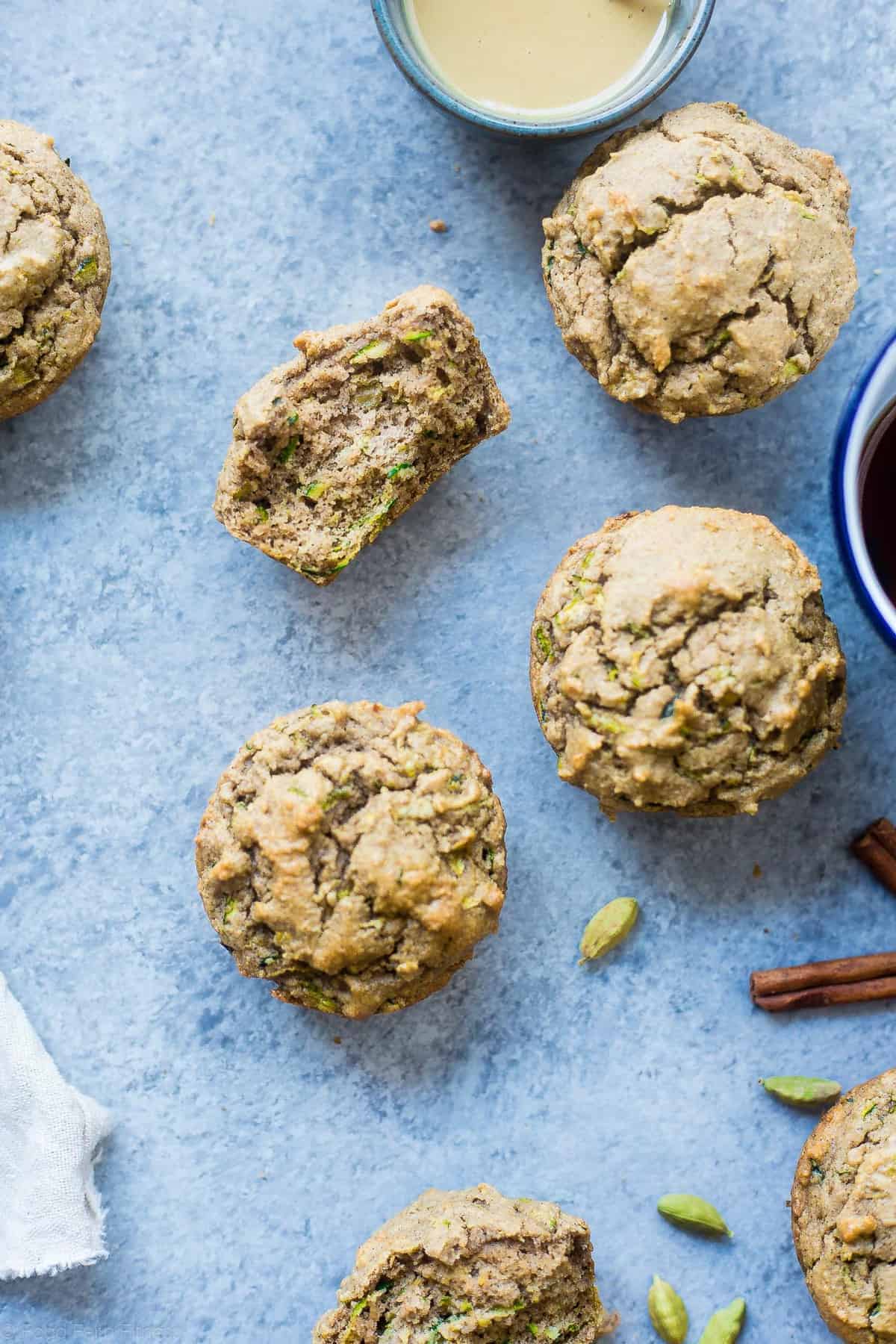 Low Carb Keto Zucchini Tahini Muffins - These low carb muffins use zucchini and tahini to make them so moist and fluffy! They're a healthy, dairy, gluten and sugar free breakfast or snack for spring! | #Foodfaithfitness | #glutenfree #lowcarb #keto #healthy #sugarfree close up of keto zucchini muffins on a table