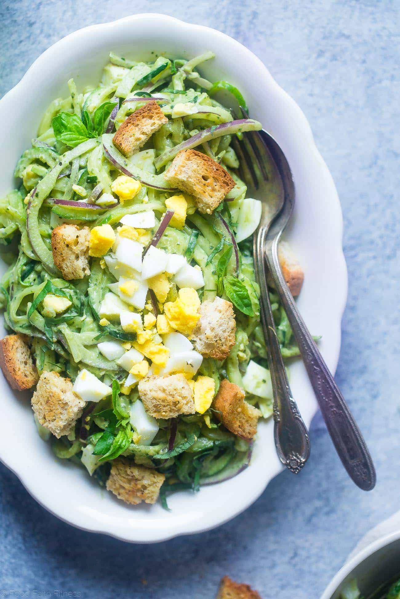 Avocado Pesto Zucchini Noodle Pasta Salad - This gluten free, healthy pasta salad uses zucchini noodles and has crunchy croutons and creamy avocado pesto! It's a low carb, easy spring side dish that's perfect for Easter! | Foodfaithfitness.com | @FoodFaithFit