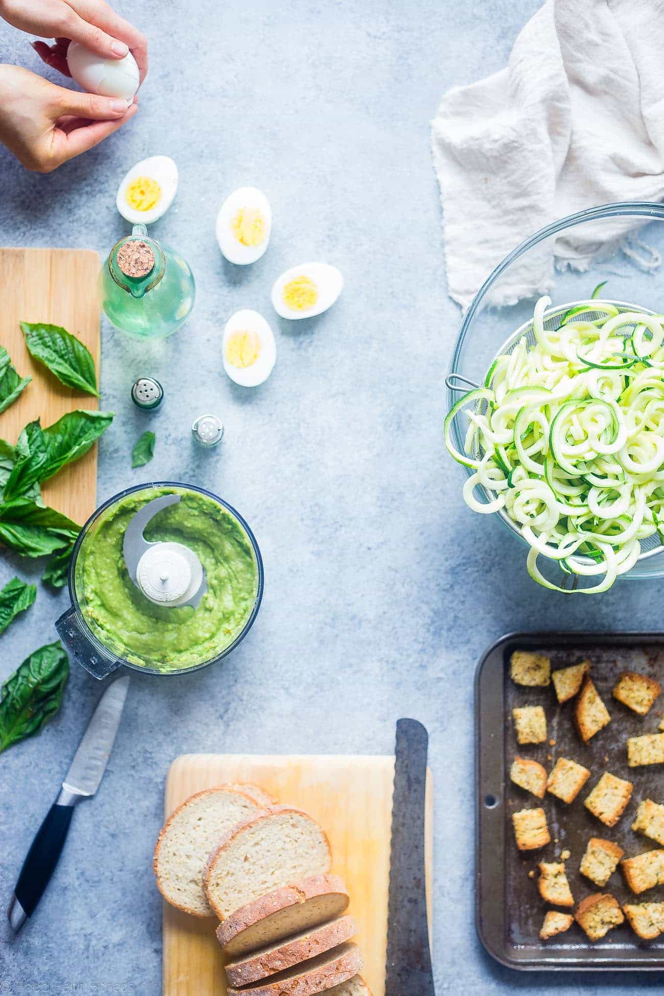 Avocado Pesto Zucchini Noodle Pasta Salad - This gluten free, healthy pasta salad uses zucchini noodles and has crunchy croutons and creamy avocado pesto! It's a low carb, easy spring side dish that's perfect for Easter! | Foodfaithfitness.com | @FoodFaithFit