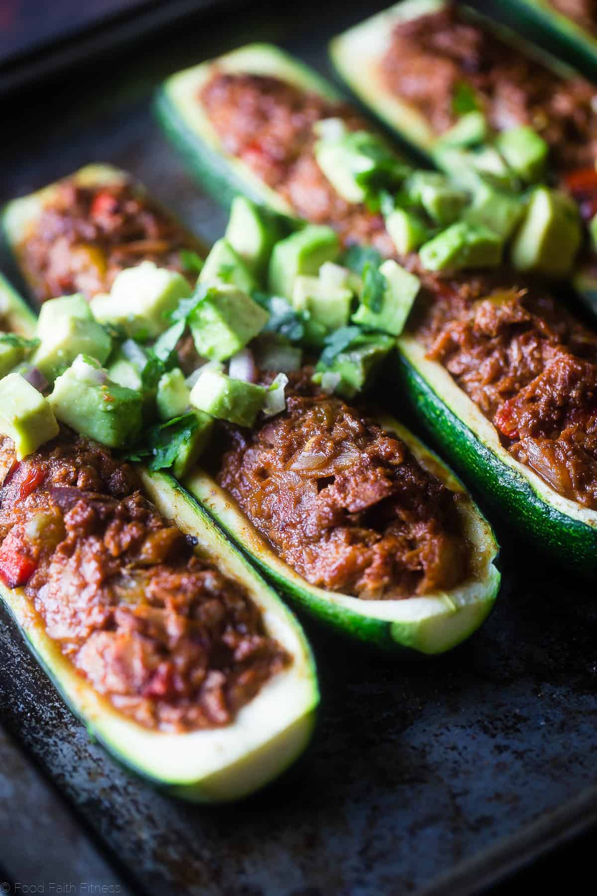 Mexican Tuna Stuffed Zucchini Boats - These quick and easy, lower carb stuffed zucchini boats are a healthy, paleo and whole30 friendly weeknight meal that are packed with protein! | Foodfaithfitness.com | @FoodFaithFit close up of Tuna Stuffed Zucchini Boats ready to be eaten