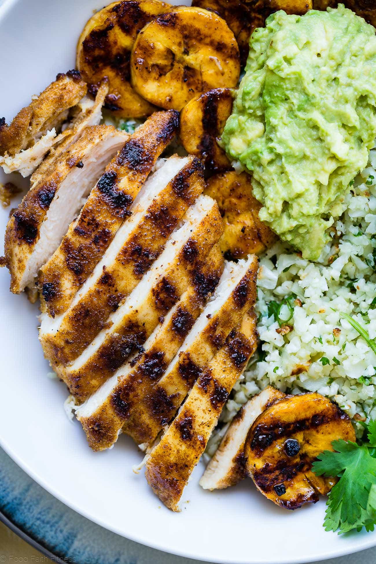 Caribbean Chicken Bowls - These paleo-friendly bowls have grilled plantains, cauliflower rice and avocado! A healthy, gluten free summer meal for under 500 calories! | #Foodfaithfitness | #Paleo #Glutenfree #Healthy #chickenrecipe