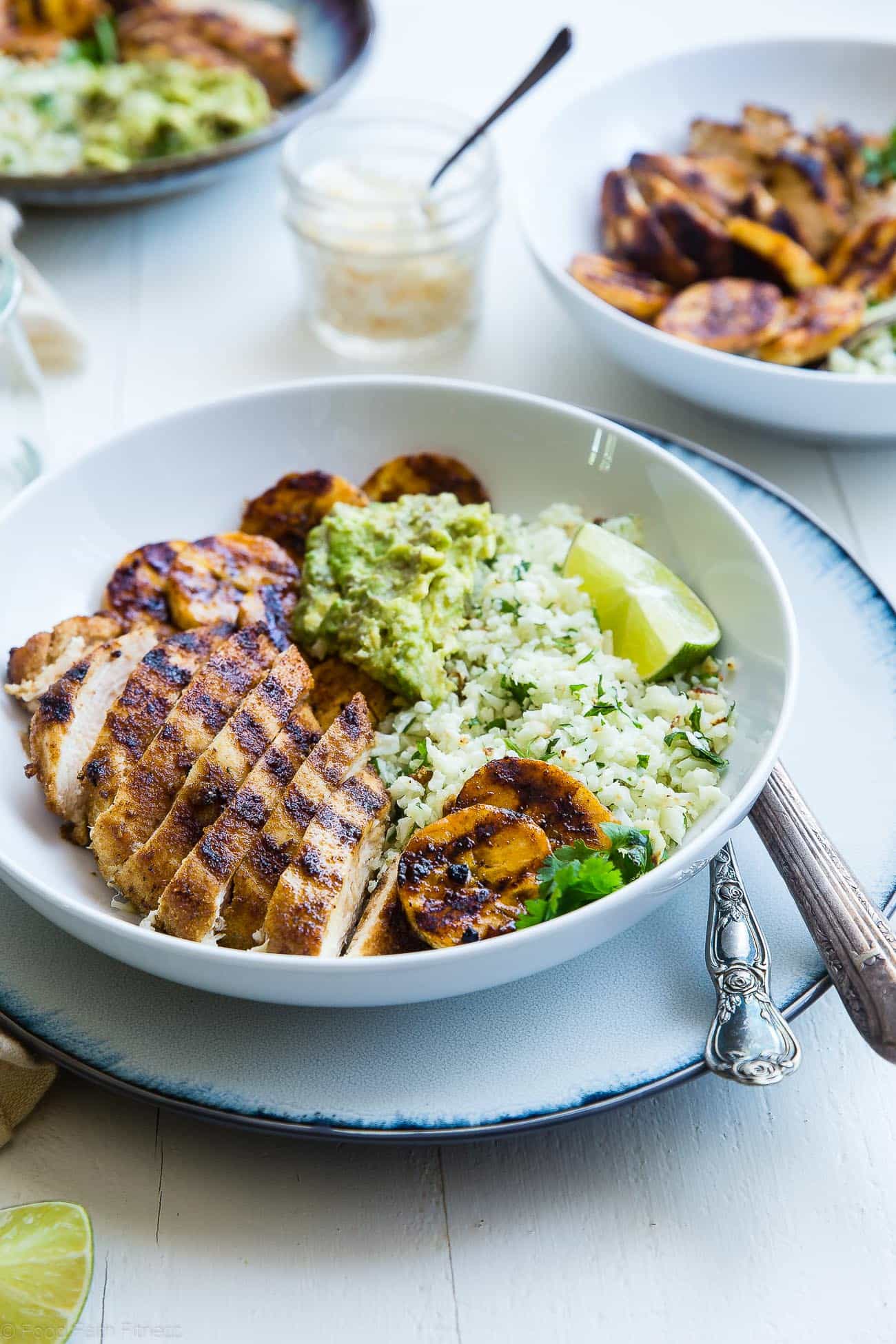 Caribbean Chicken Bowls - These paleo-friendly bowls have grilled plantains, cauliflower rice and avocado! A healthy, gluten free summer meal for under 500 calories! | #Foodfaithfitness | #Paleo #Glutenfree #Healthy #chickenrecipe