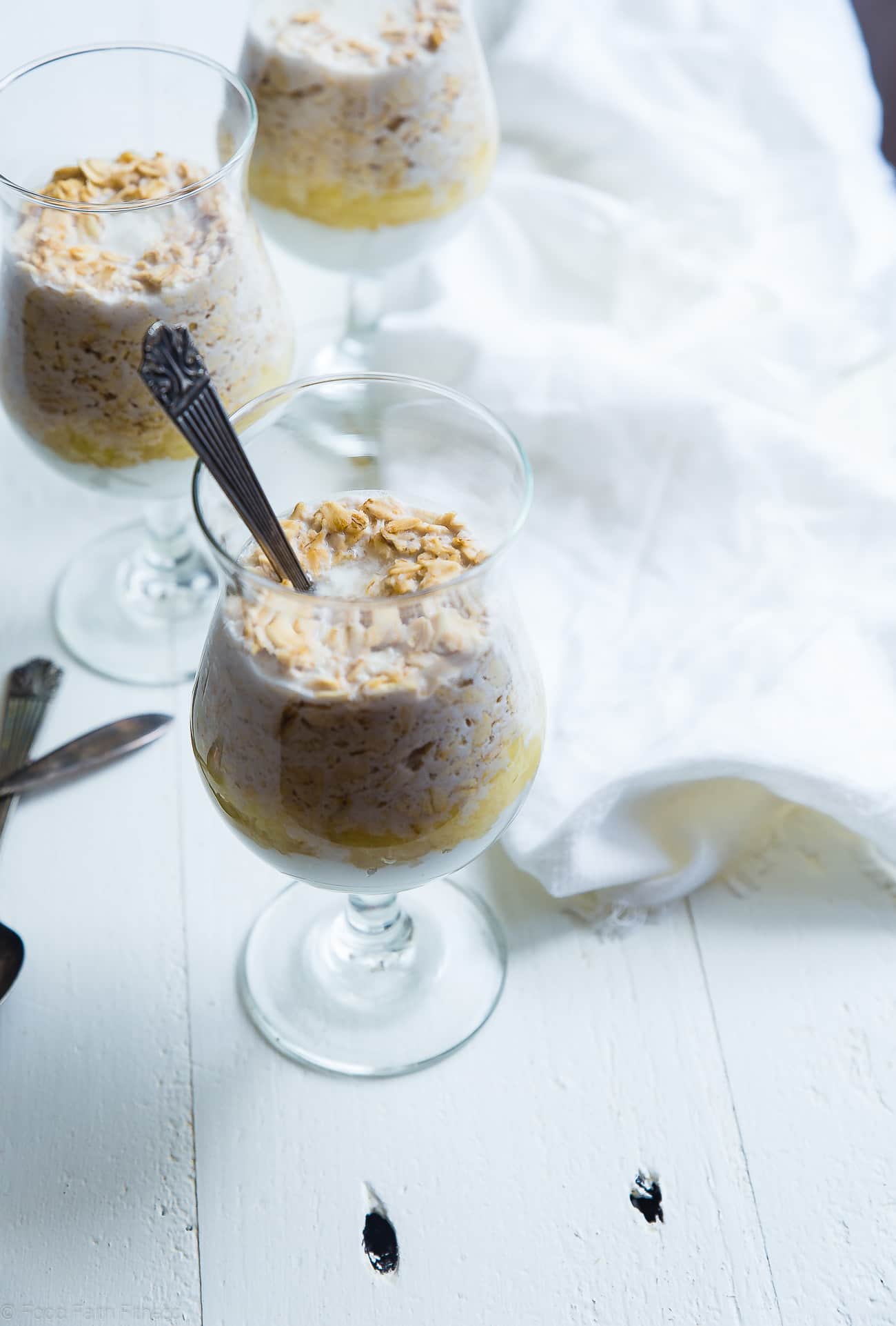 spoon in Pina Colada Overnight Oats. Recipe on Foodfaithfitness.com