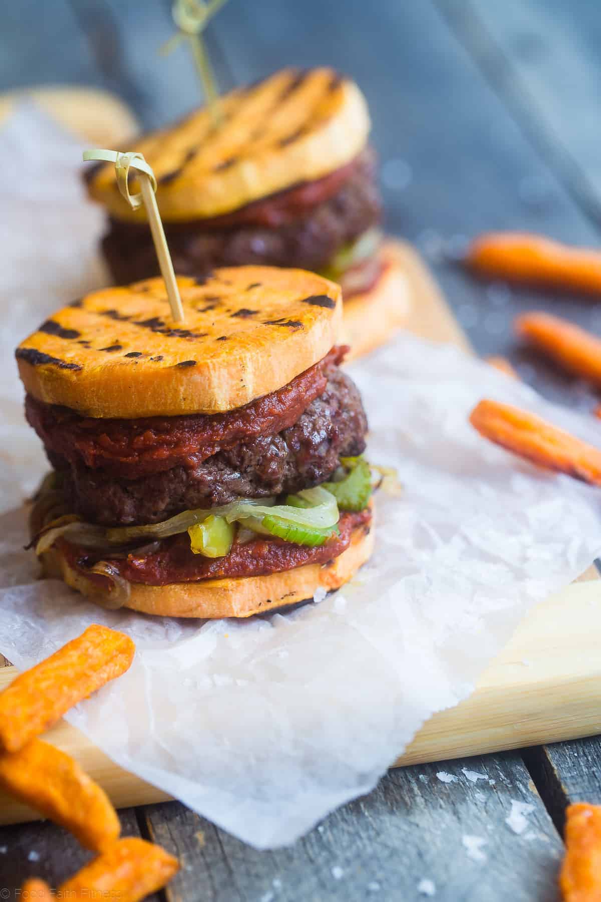 Healthy Cajun Burgers - These crowd-pleasing burgers use grilled sweet potatoes buns instead of bread! They're a healthy, whole30, gluten and dairy free summer meal for only 300 calories! | #Foodfaithfitness | #glutenfree #paleo #whole30 #healthy sweet potato bun recipe close up on a cutting block