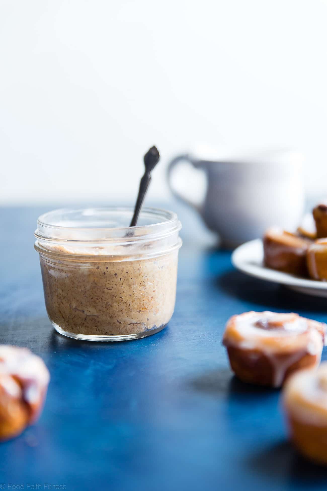 Jar of homemade cashew butter on a blue table. Recipe on Foodfaithfitness.com