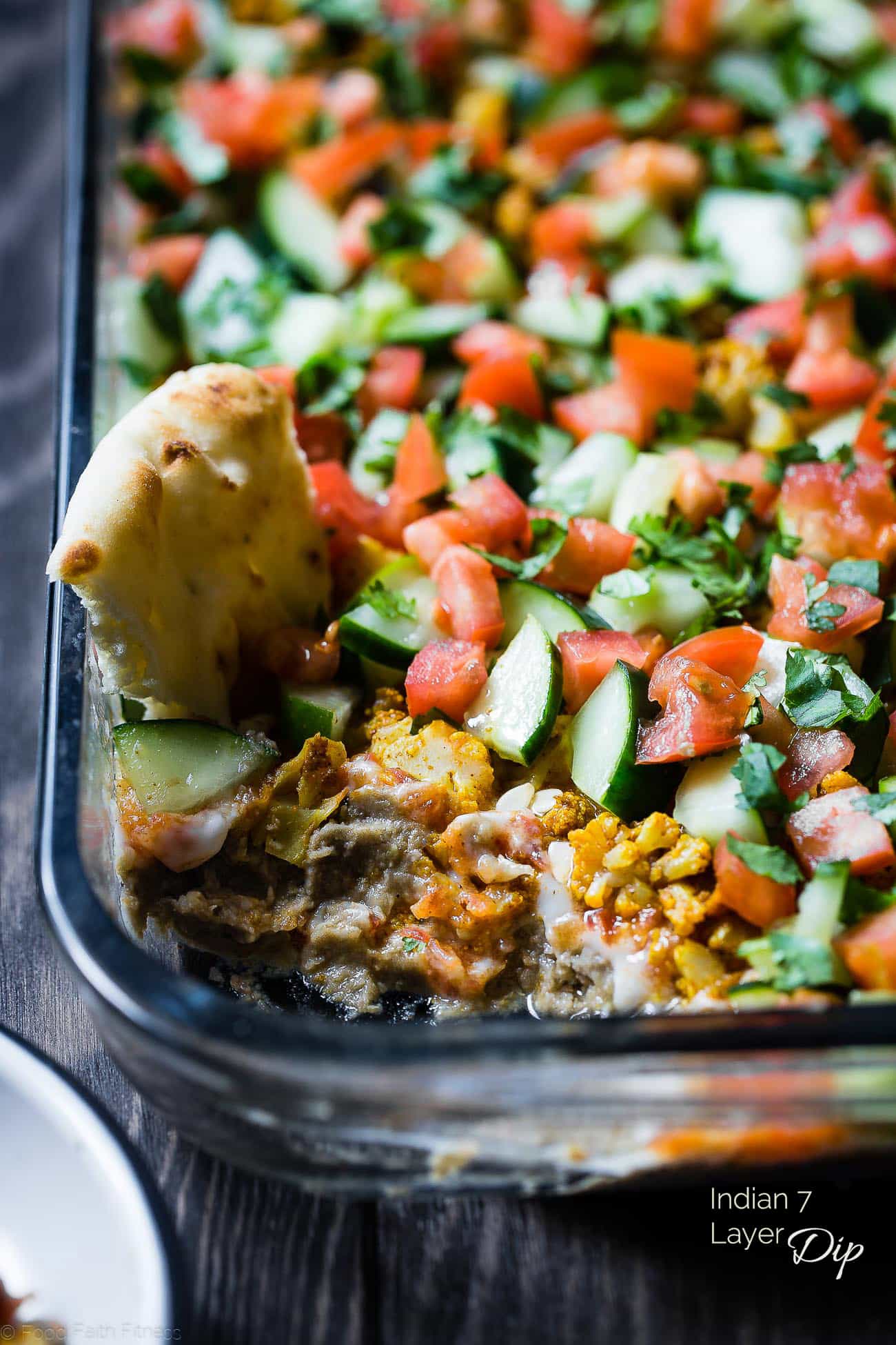 Healthy Indian 7 Layer Dip - The classic 7 layer dip recipe gets a healthy, Indian makeover! This dip is loaded with spicy, ethnic flavors and is gluten free and vegan friendly too! It's only 170 calories and perfect for game day! | Foodfaithfitness.com | @FoodFaithFit