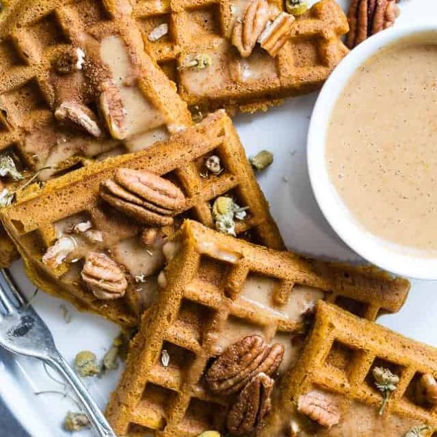 The BEST Pumpkin Spice Paleo Waffles with Pumpkin Cream Sauce - SO light, crispy and airy that you will NEVER believe that these are vegan friendly and gluten, grain, dairy AND sugar free! | Foodfaithfitness.com | @FoodFaithFit