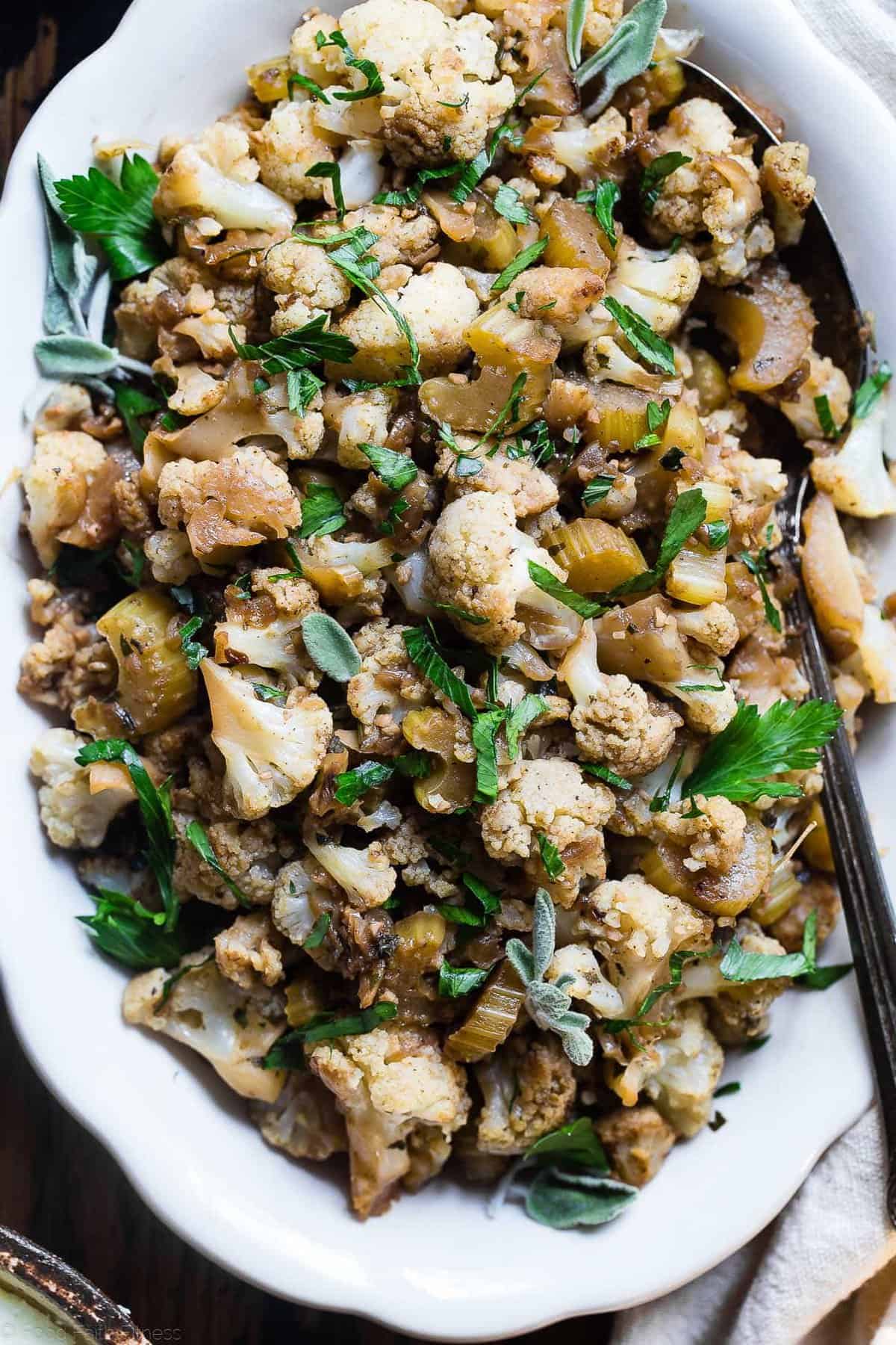 Low Carb Cauliflower Stuffing - This low carb stuffing recipe is made entirely from vegetables but has all the flavor of traditional bread stuffing! It's super easy, whole30 compliant, paleo, vegan, gluten free and SO delicious! Perfect for Thanksgiving or Christmas! | Foodfaithfitness.com | @FoodFaithFit