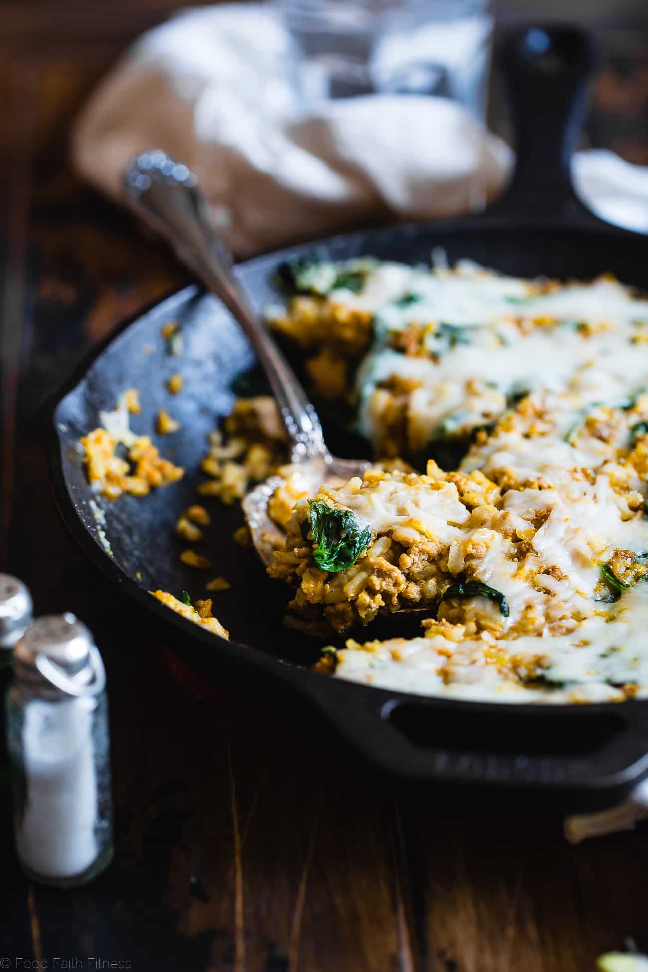 One Pot Pumpkin Rice Casserole - This rice casserole only requires one pot, under 10 ingredients and has lots of cheesy, pumpkin taste! It's an easy, gluten free, healthy fall dinner that is sure to be a crowd pleaser! | Foodfaithfitness.com | @FoodFaithFit