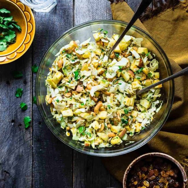 Curry Cashew Shredded Cabbage Salad with Apples - A sugar and gluten free healthy salad that is mixed with a creamy curry dressing and crunchy cashews! A healthy, paleo and whole30 side dish that everyone will love! | Foodfaithfitness.com | @FoodFaithFit
