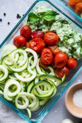 Basil Pesto Chicken Make-Ahead Bowls with zucchini noodles, roasted tomatoes, and fresh basil.