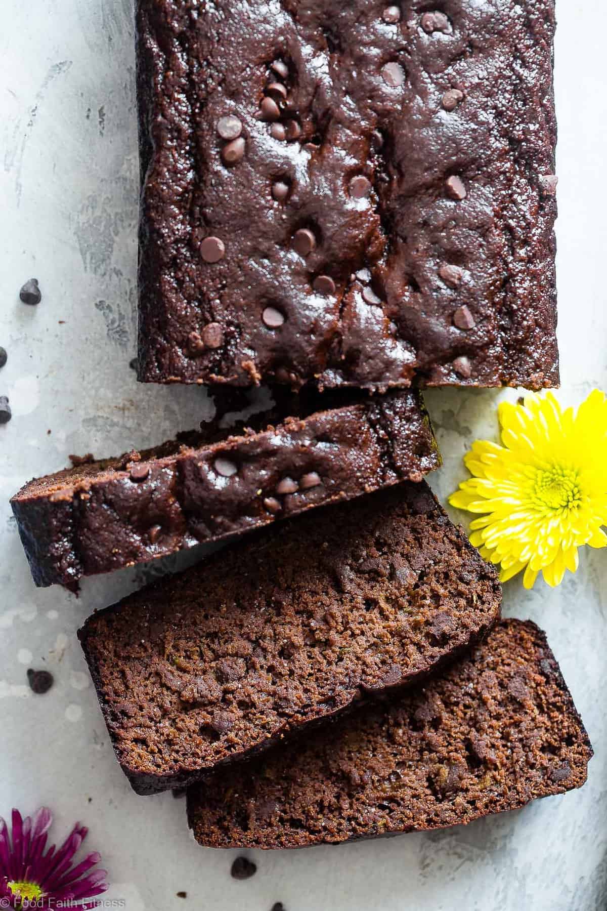 Easy Chocolate Paleo Zucchini Bread - This gluten free, almond flour Chocolate Paleo Zucchini Bread is secretly packed with protein! It's a healthy breakfast or snack that freezes great! | #Foodfaithfitness | #FoodFaithFit | #Paleo #Glutenfree #Collagen #Chocolate #Healthy close up of paleo zucchini bread with slices cut out