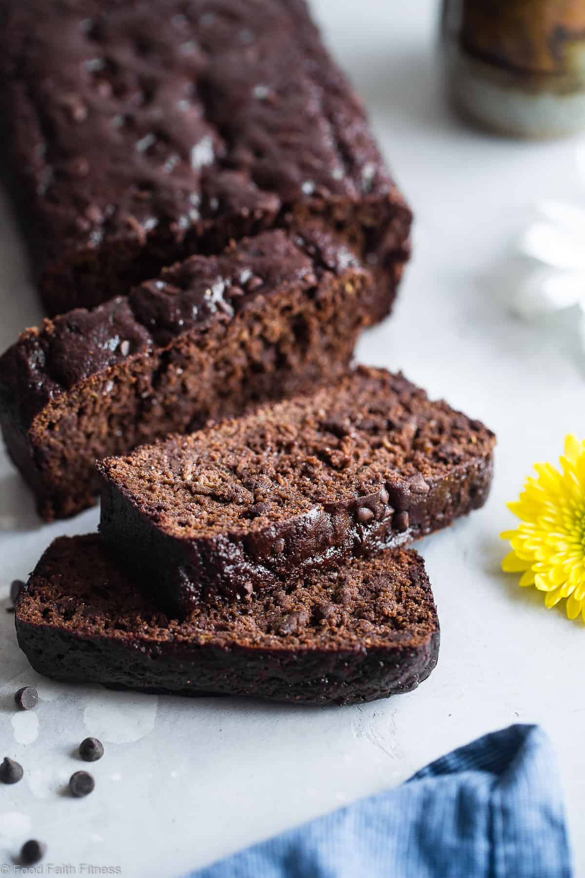 Easy Chocolate Paleo Zucchini Bread - This gluten free, almond flour Chocolate Paleo Zucchini Bread is secretly packed with protein! It's a healthy breakfast or snack that freezes great! | #Foodfaithfitness | #FoodFaithFit | #Paleo #Glutenfree #Collagen #Chocolate #Healthy close up of sliced Paleo zucchini bread on a table