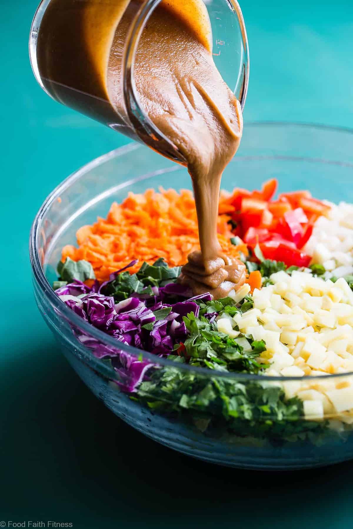 dressing being poured over a bowl of Oriental Coleslaw