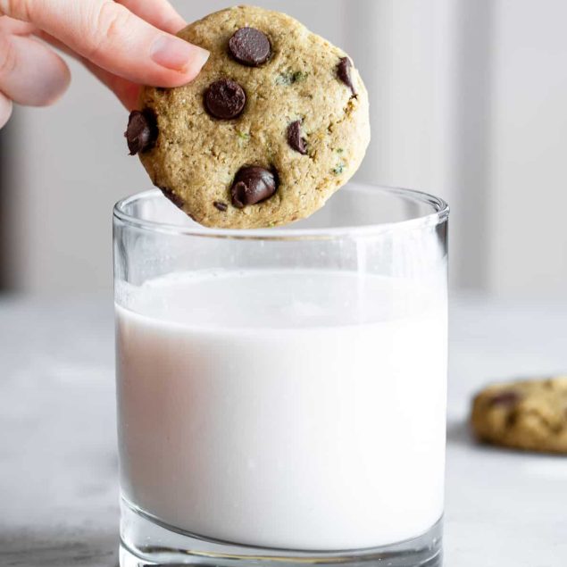 Healthy Chocolate Chip Cookie being dipped into a glass of milk