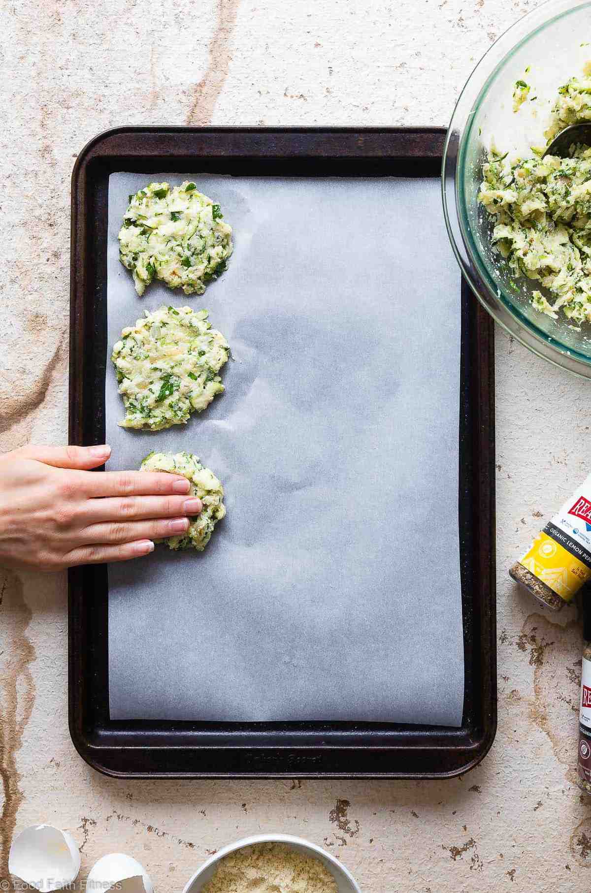 Paleo Baked Zucchini Fritters - These EAS, keto Baked Zucchini Fritters are served with an addicting lemon dill drop and are SO crispy, you'll never believe they're baked not fried! Gluten free, low carb, whole30 and insanely tasty! | #Foodfaithfitness | #Glutenfree #keto #Paleo #Whole30 #Lowcarb