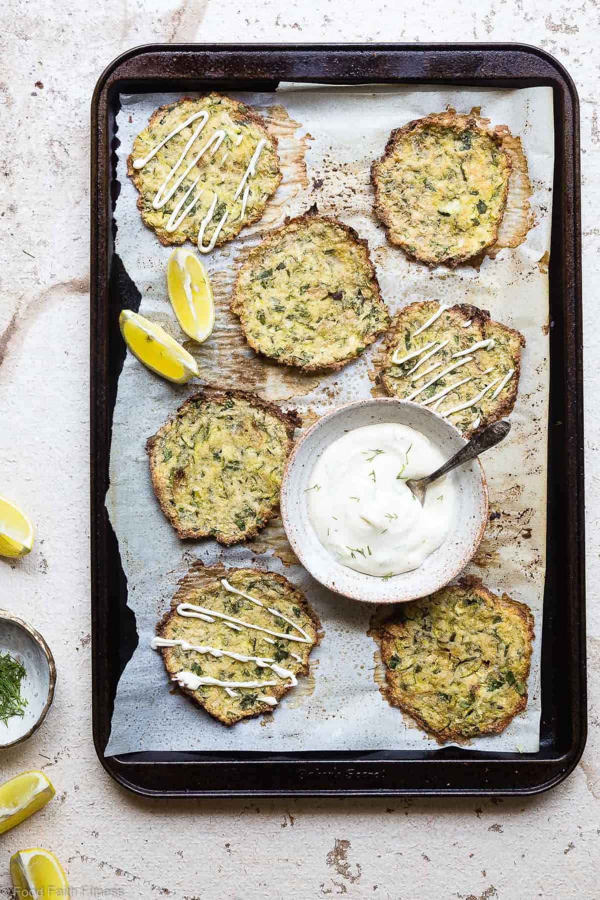Paleo Baked Zucchini Fritters - These EAS, keto Baked Zucchini Fritters are served with an addicting lemon dill drop and are SO crispy, you'll never believe they're baked not fried! Gluten free, low carb, whole30 and insanely tasty! | #Foodfaithfitness | #Glutenfree #keto #Paleo #Whole30 #Lowcarb