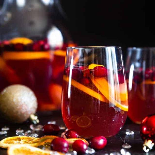 Sparkling Holiday Champagne Sangria - Full of tart cranberries and sweet oranges, this is an easy, better-for-you cocktail that is perfect to serve a crowd this Holiday season! Fizzy, festive and tasty! | #Foodfaithfitness | #Glutenfree #Sangria #Dairyfree #Vegan #Champagne