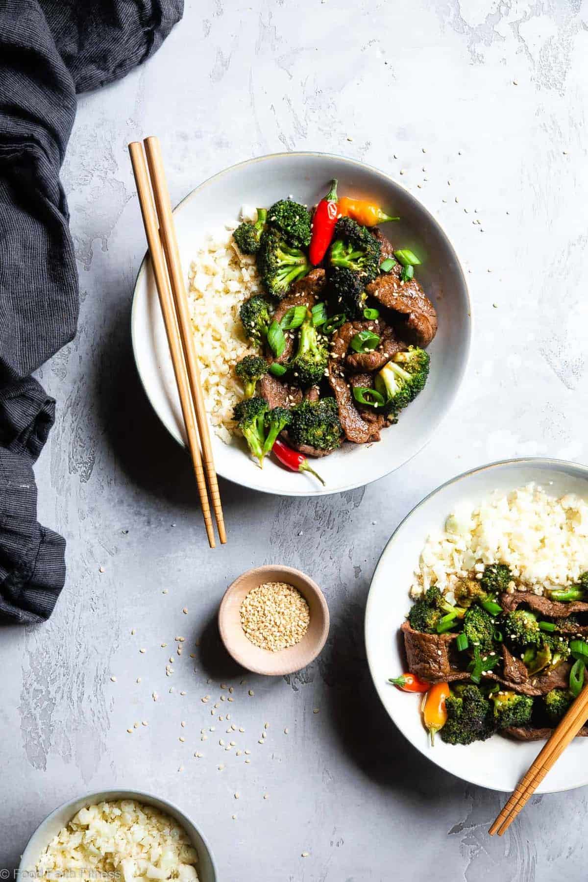 Easy Whole30 Low Carb Beef and Broccoli - This keto beef and broccoli is an EASY, one-pot weeknight meal that even picky eaters will love! So much yummier and healthier than takeout too! | #Foodfaithfitness | #Glutenfree #Keto #Paleo #Lowcarb #Whole30 two bowls of Keto Beef and Broccoli on a table