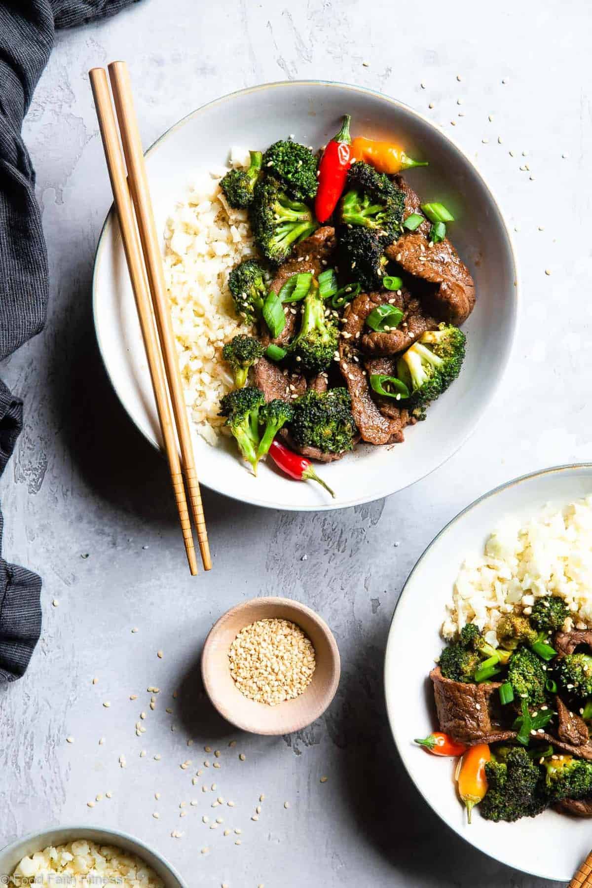 Easy Whole30 Low Carb Beef and Broccoli - This keto beef and broccoli is an EASY, one-pot weeknight meal that even picky eaters will love! So much yummier and healthier than takeout too! | #Foodfaithfitness | #Glutenfree #Keto #Paleo #Lowcarb #Whole30 Keto Beef and Broccoli in two bowls with chop sticks