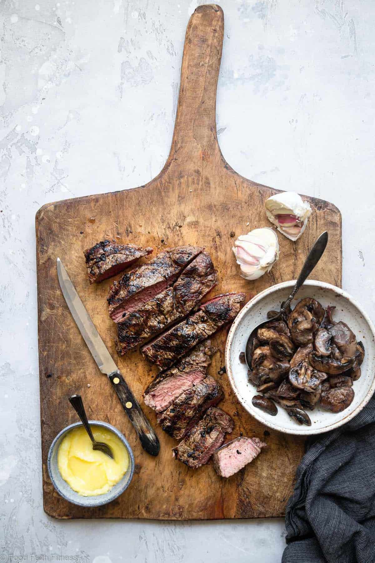 Keto Steak with Garlic Butter Mushrooms - This keto steak recipe is topped with garlic butter mushrooms and grilled to perfection! A low carb, paleo and whole30 healthy Summer dinner! | #Foodfaithfitness | #Glutenfree #Paleo #Keto #Lowcarb #whole30 sliced keto steak with mushrooms in a bowl