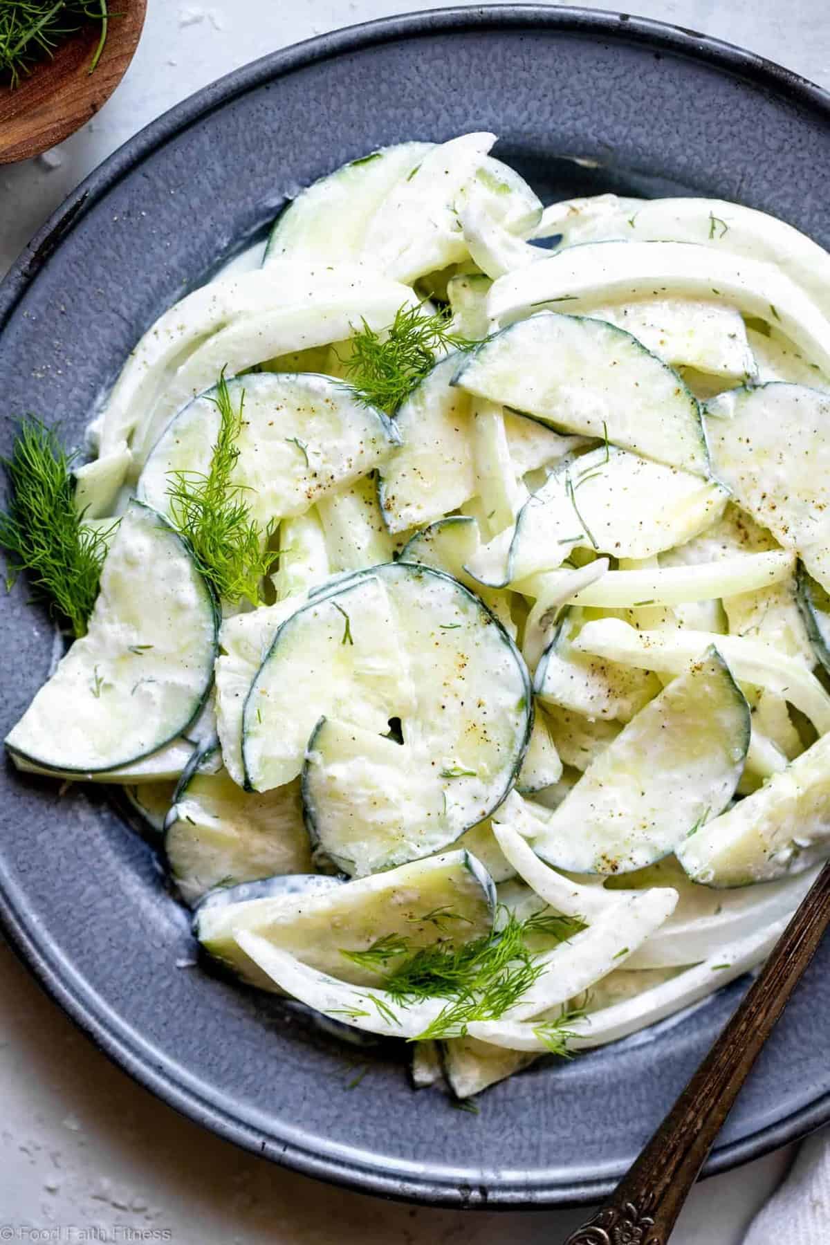 Low Carb Keto Cucumber Salad - An easy summer side that uses only 6 pantry essential ingredients! Creamy, naturally gluten free and only 50 calories! | #Foodfaithfitness | #Keto #Lowcarb #Glutenfree #Dairyfree #Sugarfree Close up of cucumber salad on a plate