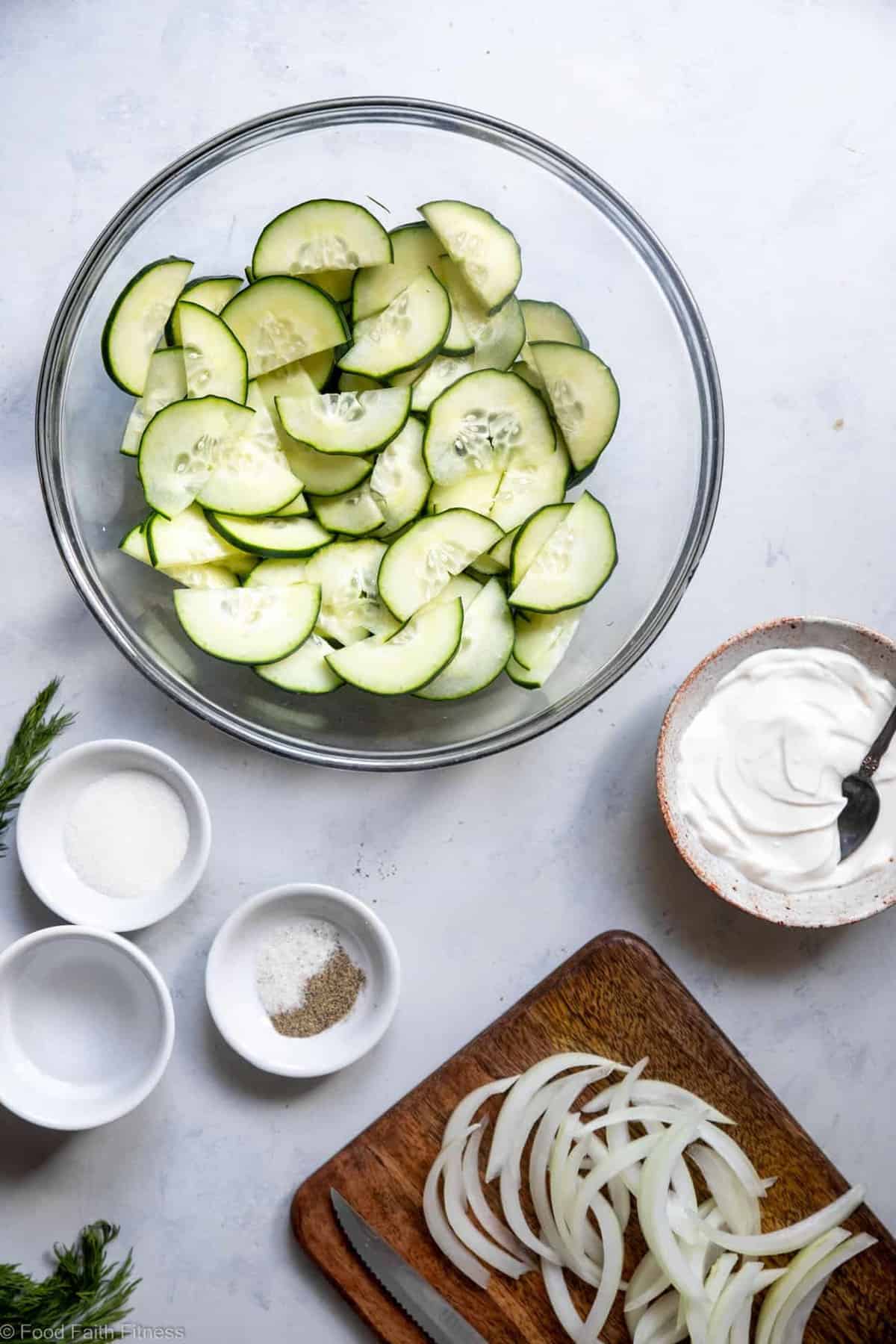 Low Carb Keto Cucumber Salad - An easy summer side that uses only 6 pantry essential ingredients! Creamy, naturally gluten free and only 50 calories! | #Foodfaithfitness | #Keto #Lowcarb #Glutenfree #Dairyfree #Sugarfree an image of a bowl of the best cucumber salad