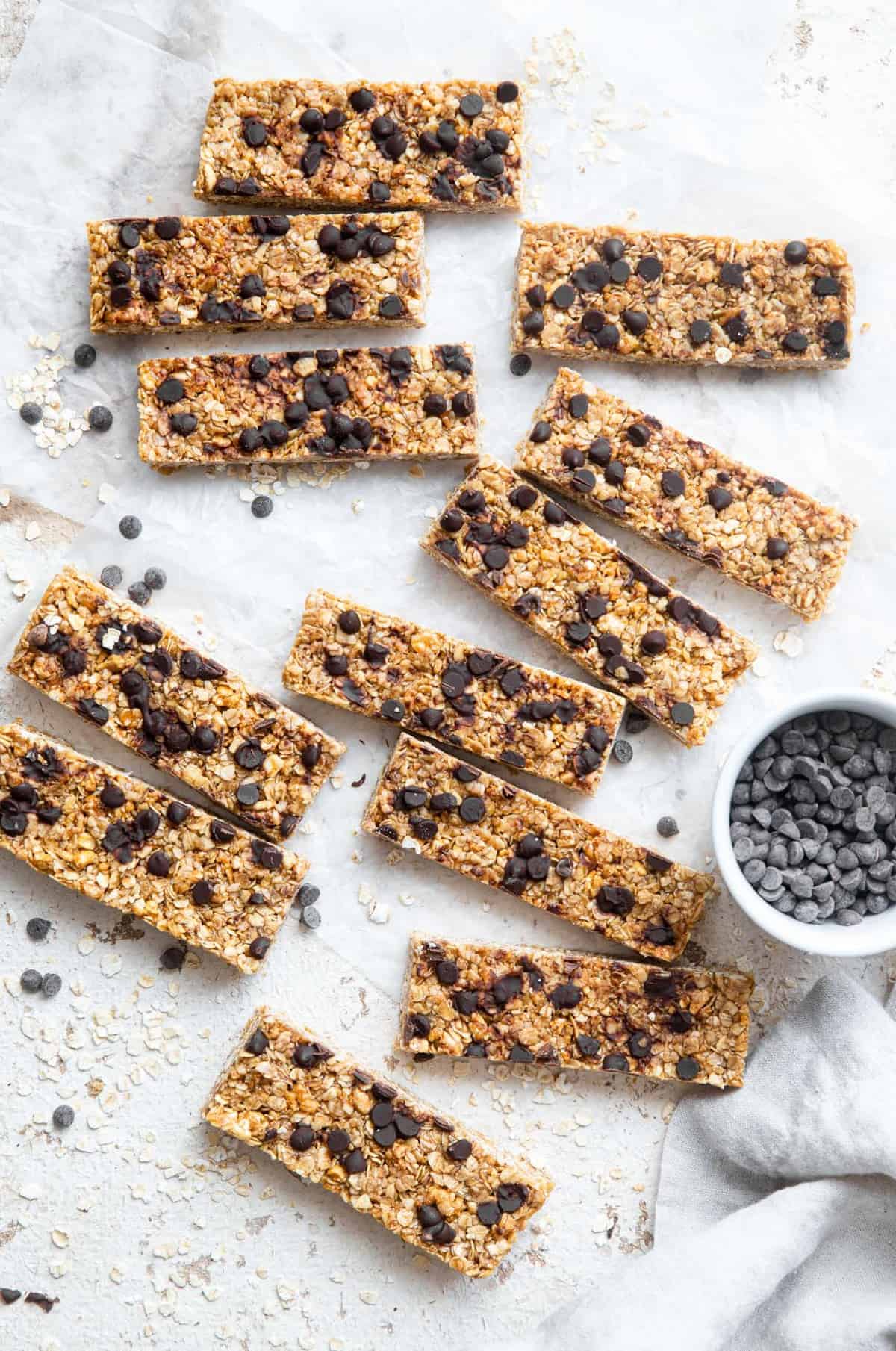 Healthy Chewy Chocolate Chip Granola Bars - This Healthy Chewy Granola Bar Recipe is made with wholesome, simple, pantry essential ingredients! Loaded with chocolate chips and great for kids or adults! | #Foodfaithfitness | #kidfriendly #healthy #snack #eggfree #backtoschool the best granola bar recipe on a table