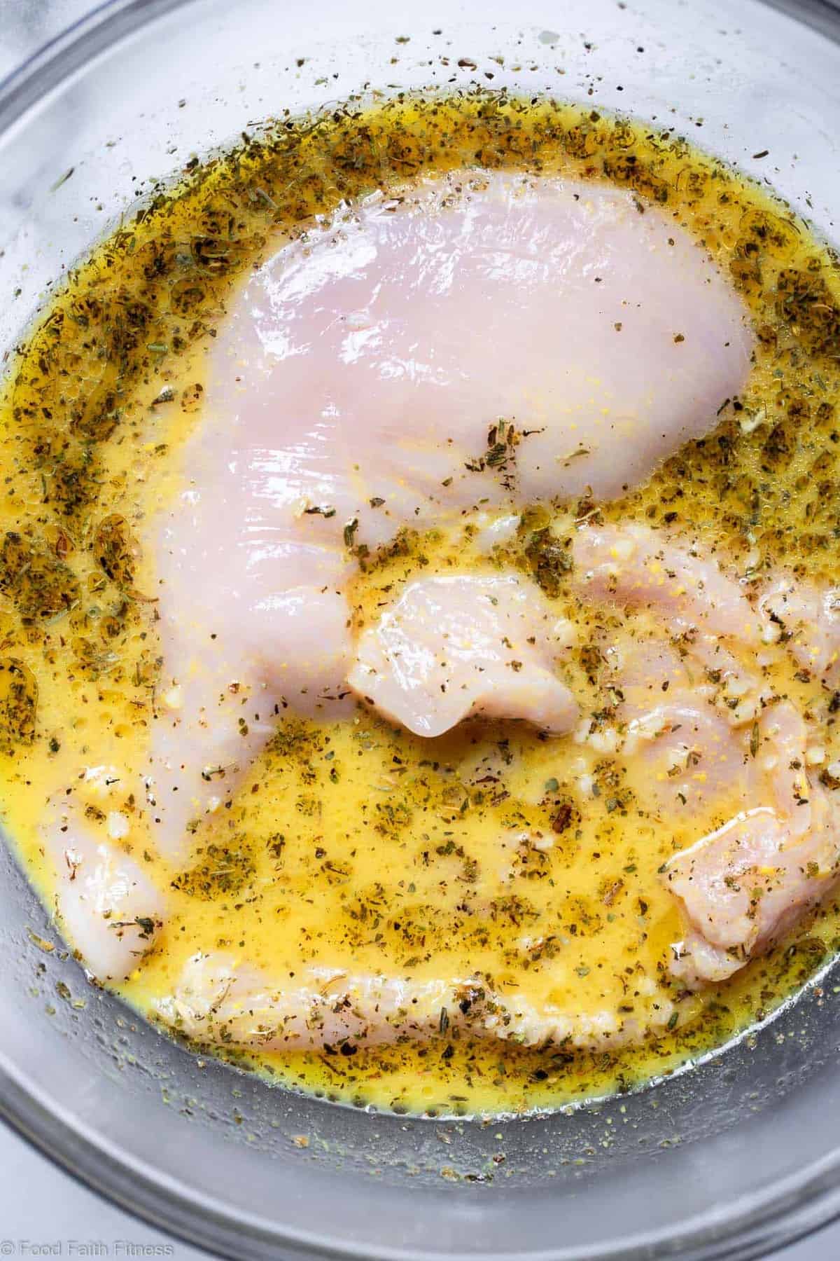 How to Grill Chicken Breast that is SUPER Juicy - Ever wondered how to grill chicken breast that is actually juicy and not dry? Learn the simple ways to make perfect grilled chicken breast! | Foodfaithfitness.com | #healthy #lowcarb #glutenfree #keto #paleo Grilled Chicken breast in a bowl of marinade