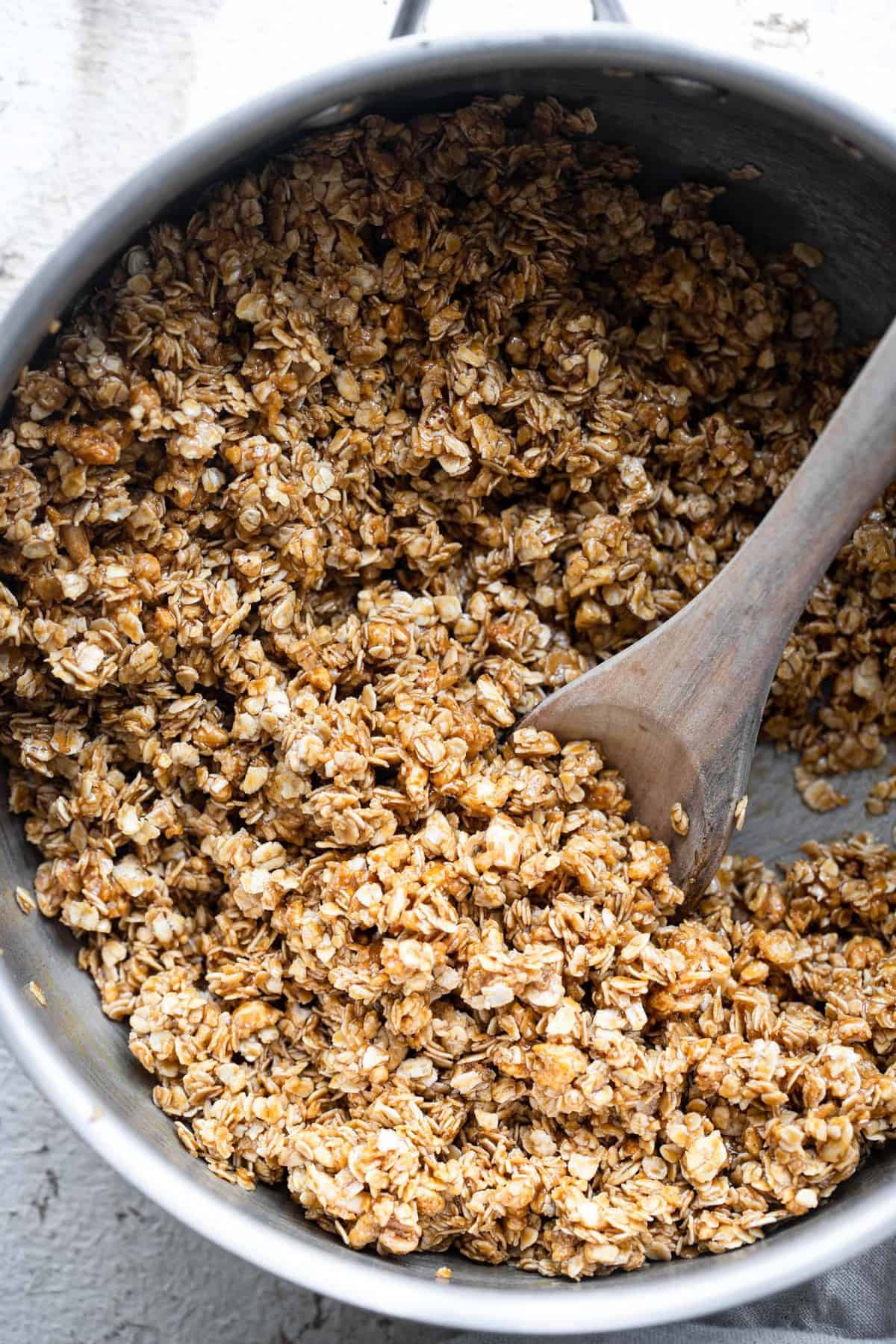 Healthy Chewy Chocolate Chip Granola Bars - This Healthy Chewy Granola Bar Recipe is made with wholesome, simple, pantry essential ingredients! Loaded with chocolate chips and great for kids or adults! | #Foodfaithfitness | #kidfriendly #healthy #snack #eggfree #backtoschool making easy homemade granola bars in a pan