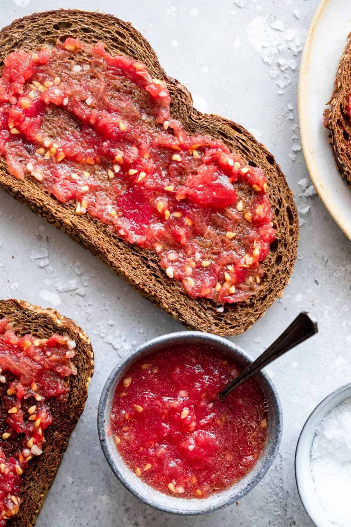 Pan Con Tomate - Tomato toast is a traditional Spanish breakfast that is made from 4 simple, healthy ingredients and has big flavor! This will be your new go to breakfast! Naturally Paleo, low carb and vegan too! | #Foodfaithfitness | #Glutenfree #Paleo #Lowcarb #Vegan #sugarfree close of tomato bread