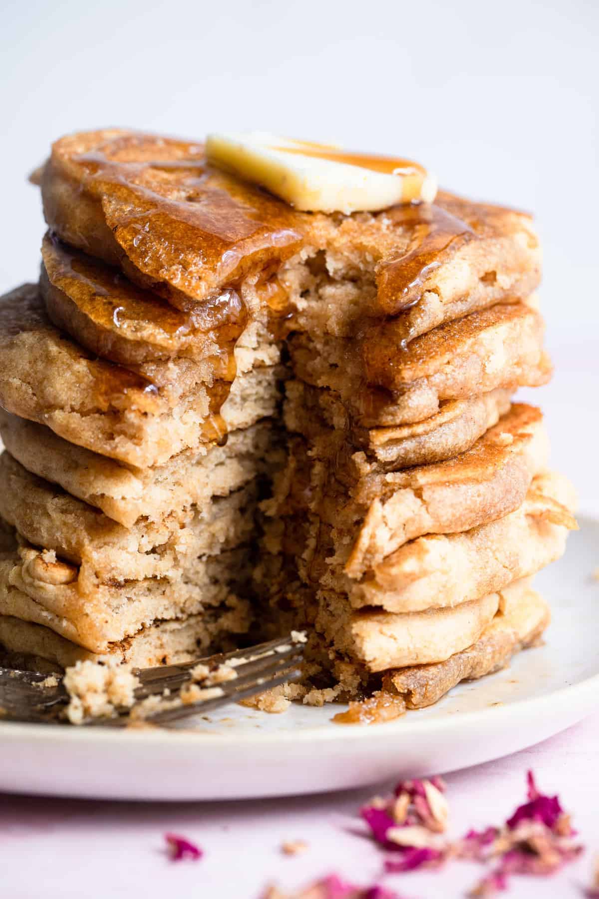 Fluffy Whole Wheat Vegan Pancakes -These healthy Vegan Pancakes are so fluffy and light you will never know they are healthy, whole grain and dairy and egg free! Your new go to recipe! | #Foodfaithfitness | #healthy #vegan #eggfree #dairyfree #wholewheat close up of Healthy Vegan Pancakes that are cut