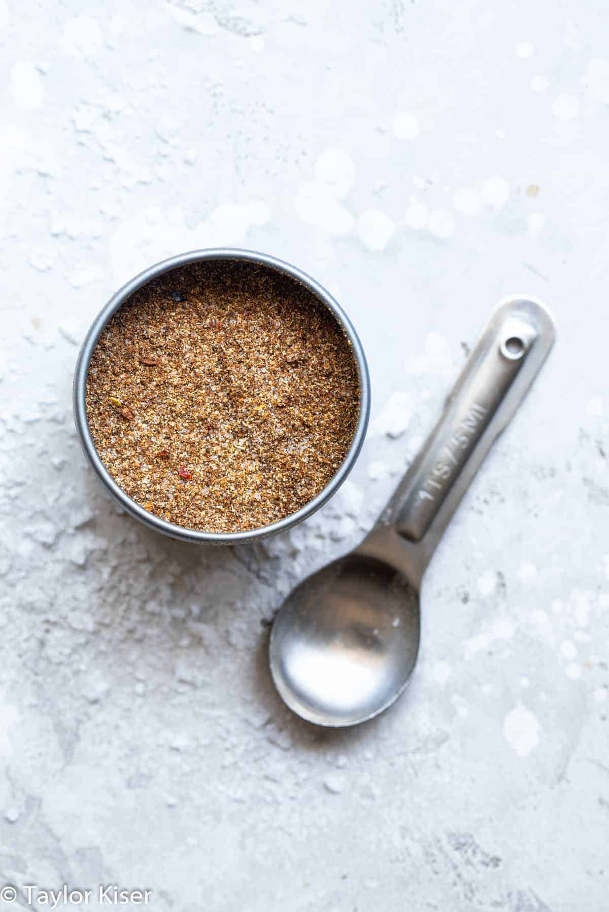 Homemade fajita mix in a spice container on a counter