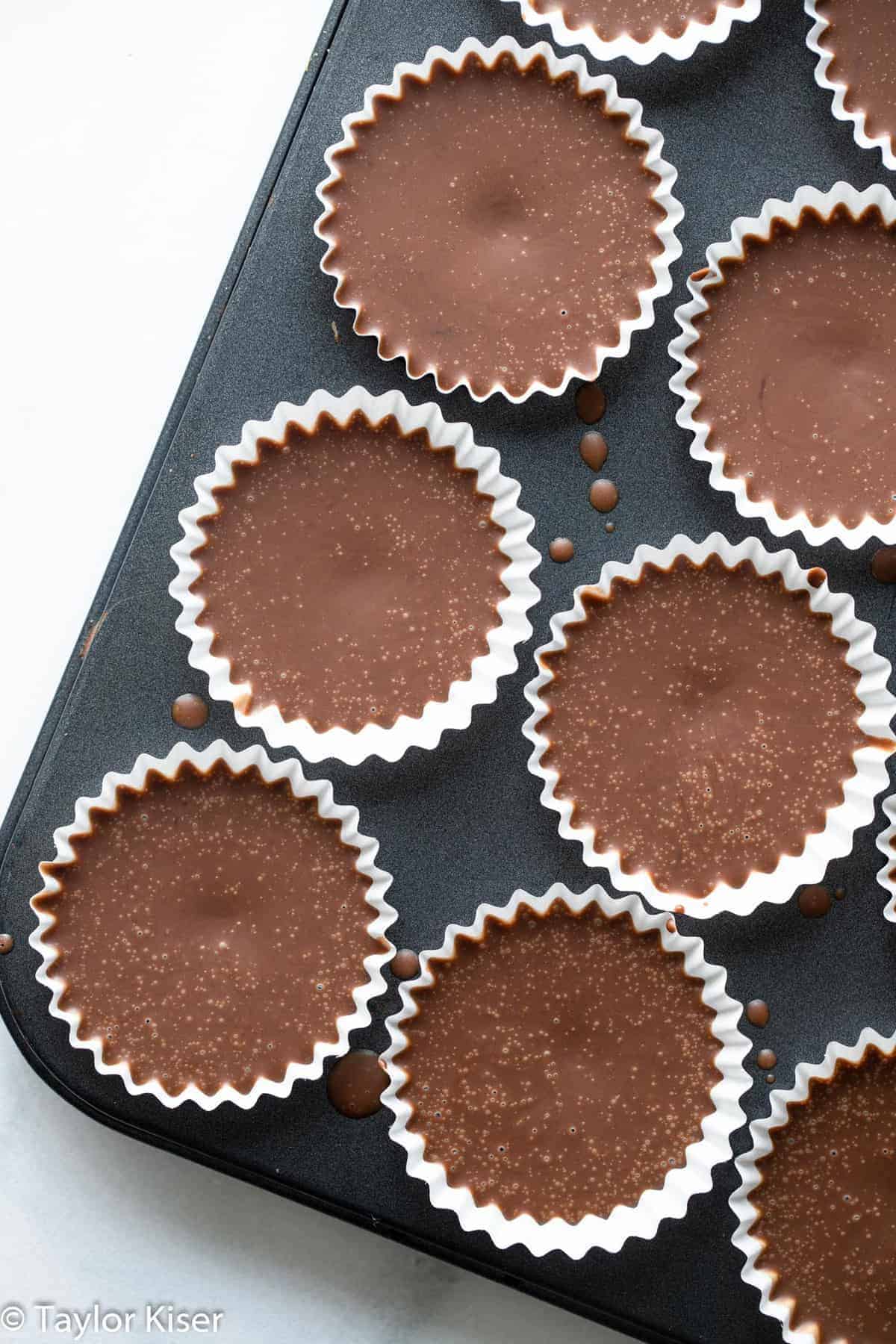 No Bake Keto Chocolate Peanut Butter Fat Bombs - These No Bake Fat Bombs are an easy, 4 ingredient dessert that are sugar free, gluten free and low carb! Delicious and simple even if you're not keto! | #Foodfaithfitness | #glutenfree #lowcarb #sugarfree #keto #healthy chocolate peanut butter keto fat bombs in a muffin tin