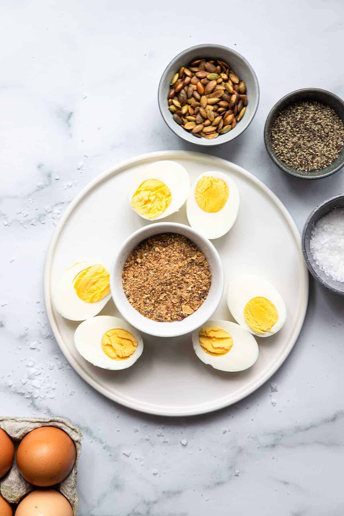 hard boiled egg snacks on a plate with salt and pepper