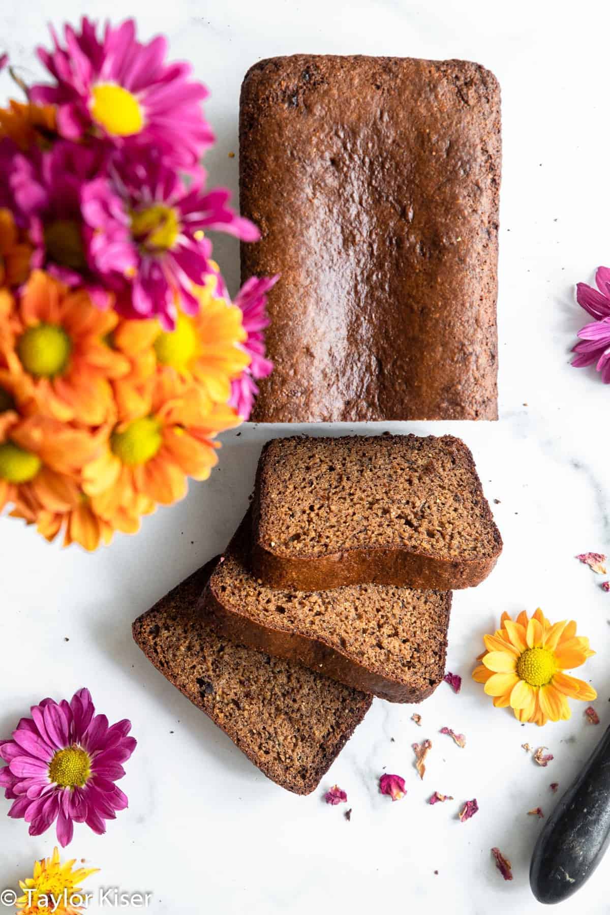 High Protein Banana Bread - This easy banana bread is naturally gluten free and packed with protein! Moist, tender, easy to make and so delicious! The best snack or breakfast! | #Foodfaithfitness | #Glutenfree #healthy #proteinpowder #paleo #grainfree overhead of protein powder banana bread sliced on a table