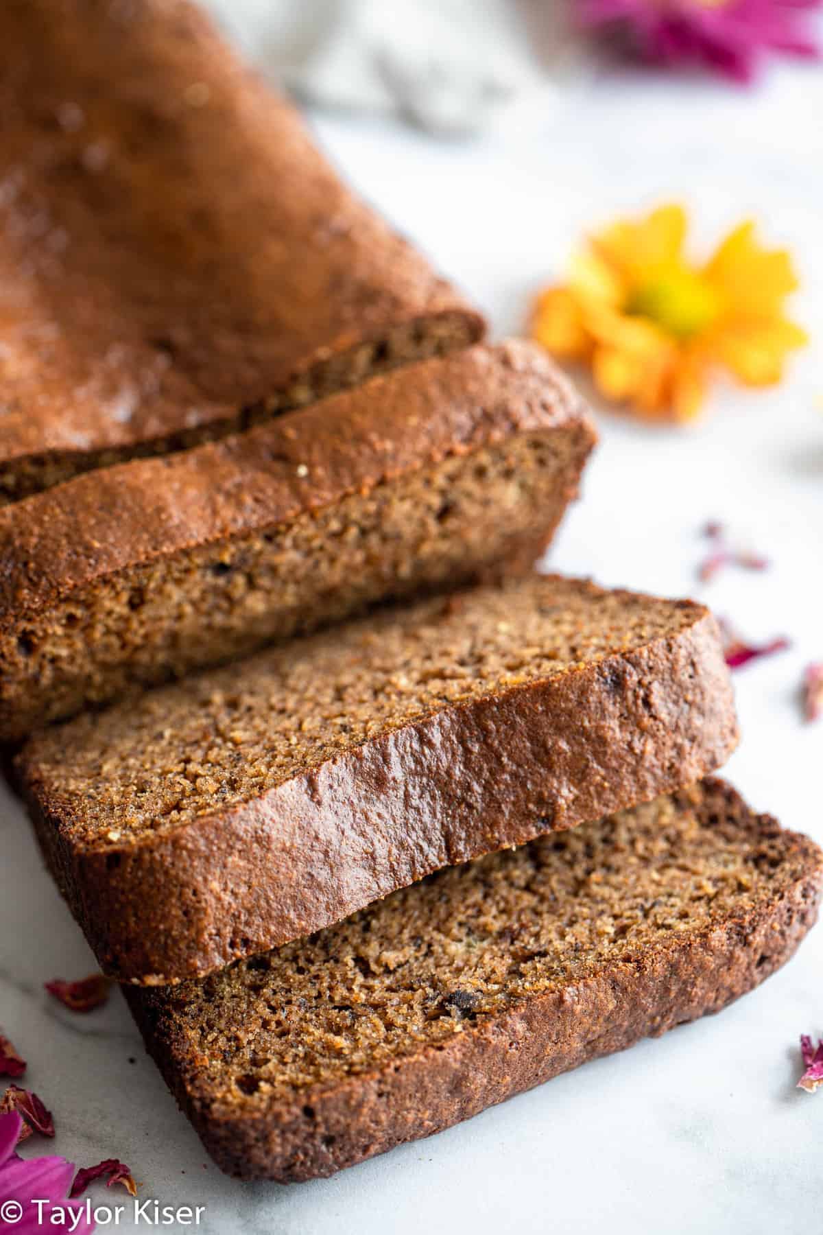 High Protein Banana Bread - This easy banana bread is naturally gluten free and packed with protein! Moist, tender, easy to make and so delicious! The best snack or breakfast! | #Foodfaithfitness | #Glutenfree #healthy #proteinpowder #paleo #grainfree slices of protein banana bread on a table
