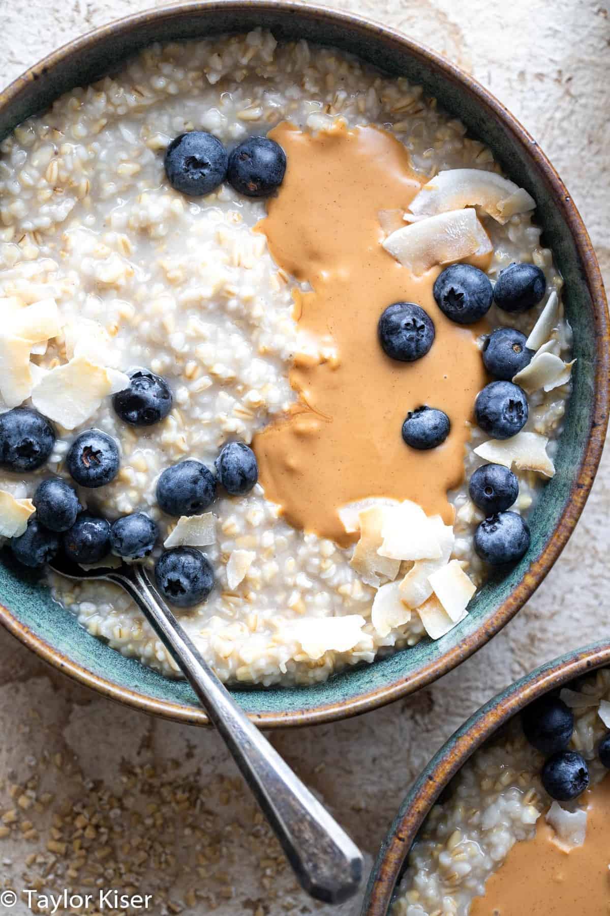 overnight steel cut oats topped with blueberries and nut butter