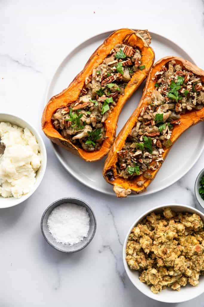 vegan butternut squash on a plate with a bowl of mashed potatoes on the side