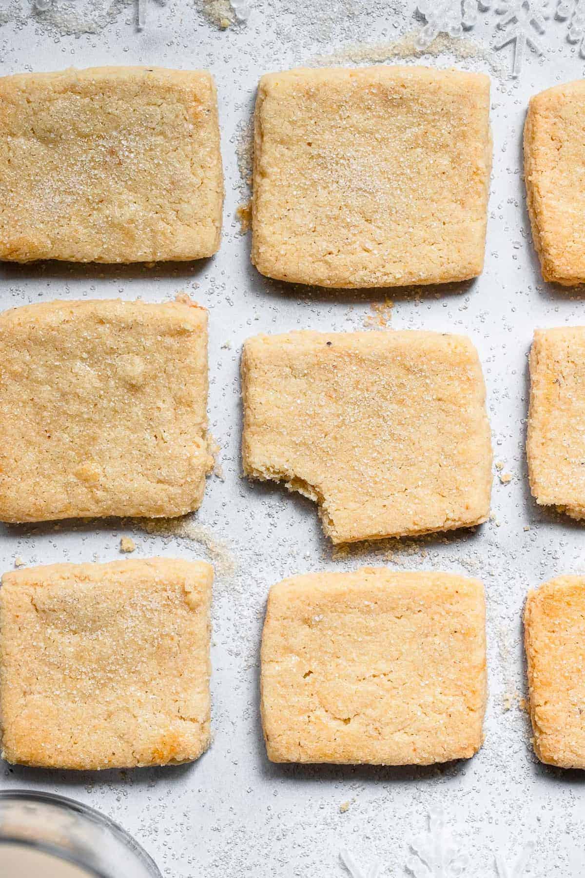 Gluten Free Almond Flour Shortbread Cookies - Only 6 simple ingredients and melt in your mouth! Naturally gluten free, delicious and perfect for the holidays! | #Foodfaithfitness | #Glutenfree #christmas #shortbread #healthy almond flour butter cookies in a row and one has a bite out of it