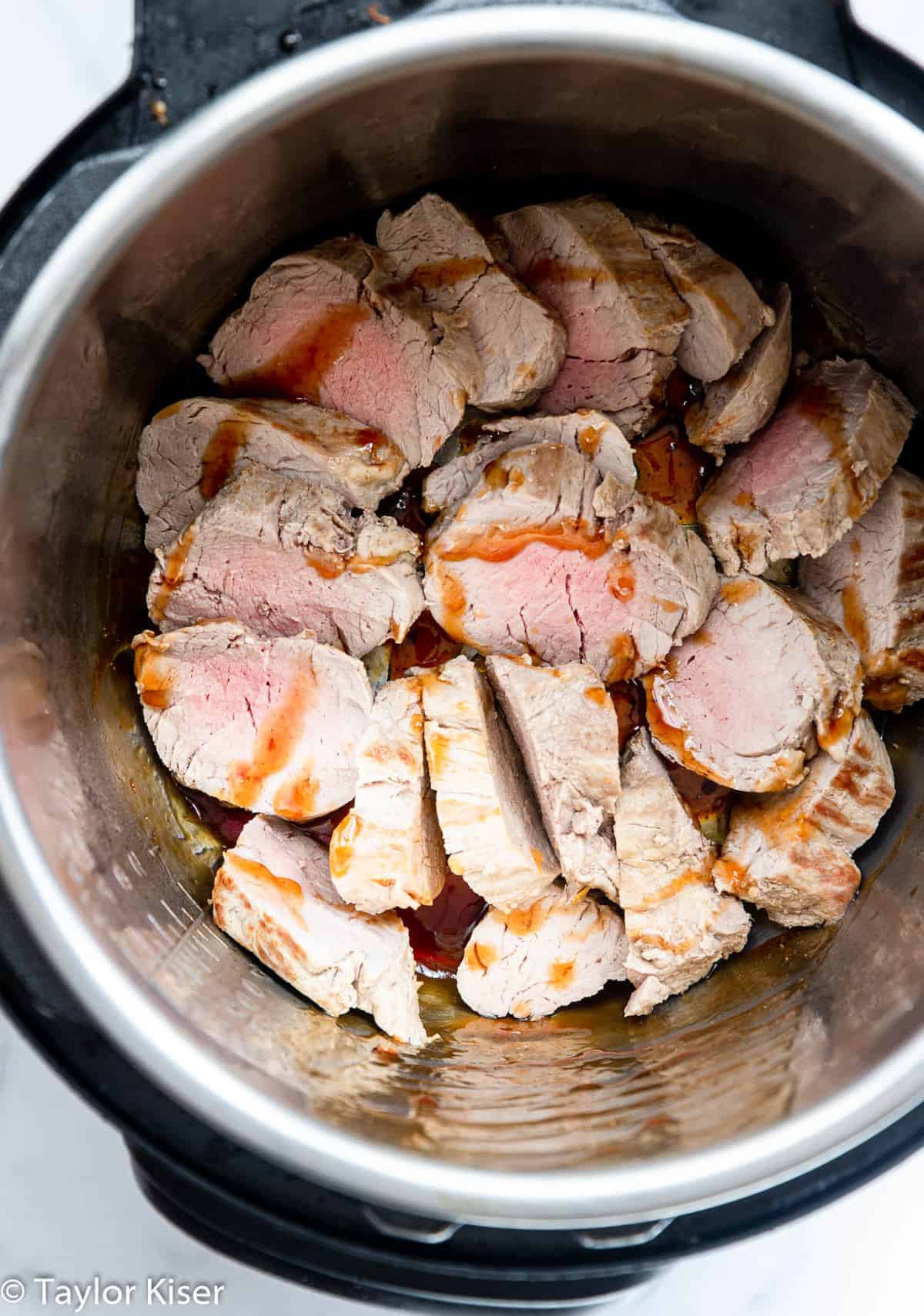 Asian Instant Pot Pork Tenderloin - This Instant Pot Pork Tenderloin is an easy, healthy 20 minute weeknight dinner with yummy, Asian flavor. Naturally gluten free so delicious! | #Foodfaithfitness | #glutenfree #paleo #lowcarb #instantpot #healthy Instant Pot Pork Tenderloin cooking in an Instant Pot