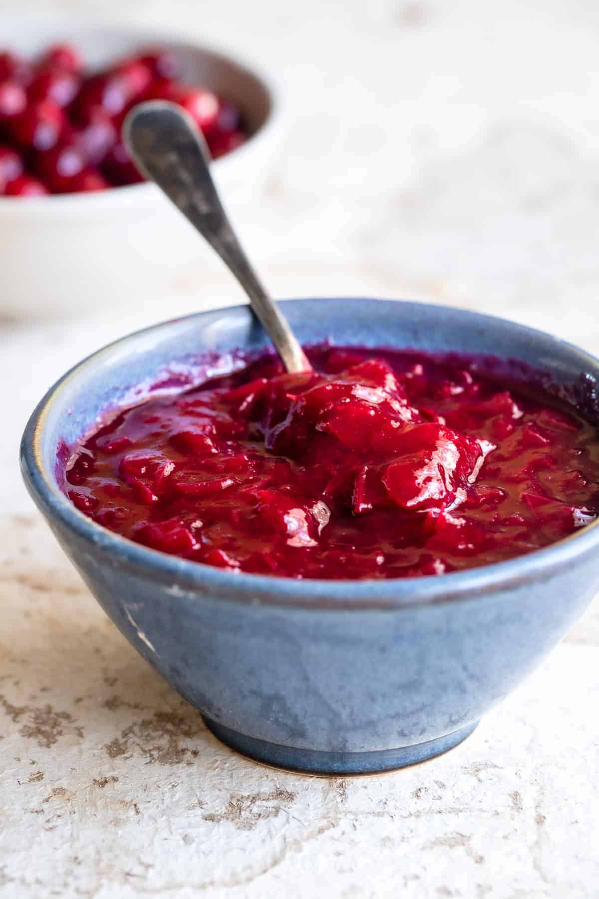 Low Carb Sugar Free Keto Cranberry Sauce - this Keto Cranberry Sauce is only 3 ingredients and SO easy to make! It's better than store bought, naturally gluten free and healthy! | #Foodfaithfitness | #glutenfree #paleo #keto #sugarfree #lowcarb close up photo of cranberry sauce without sugar