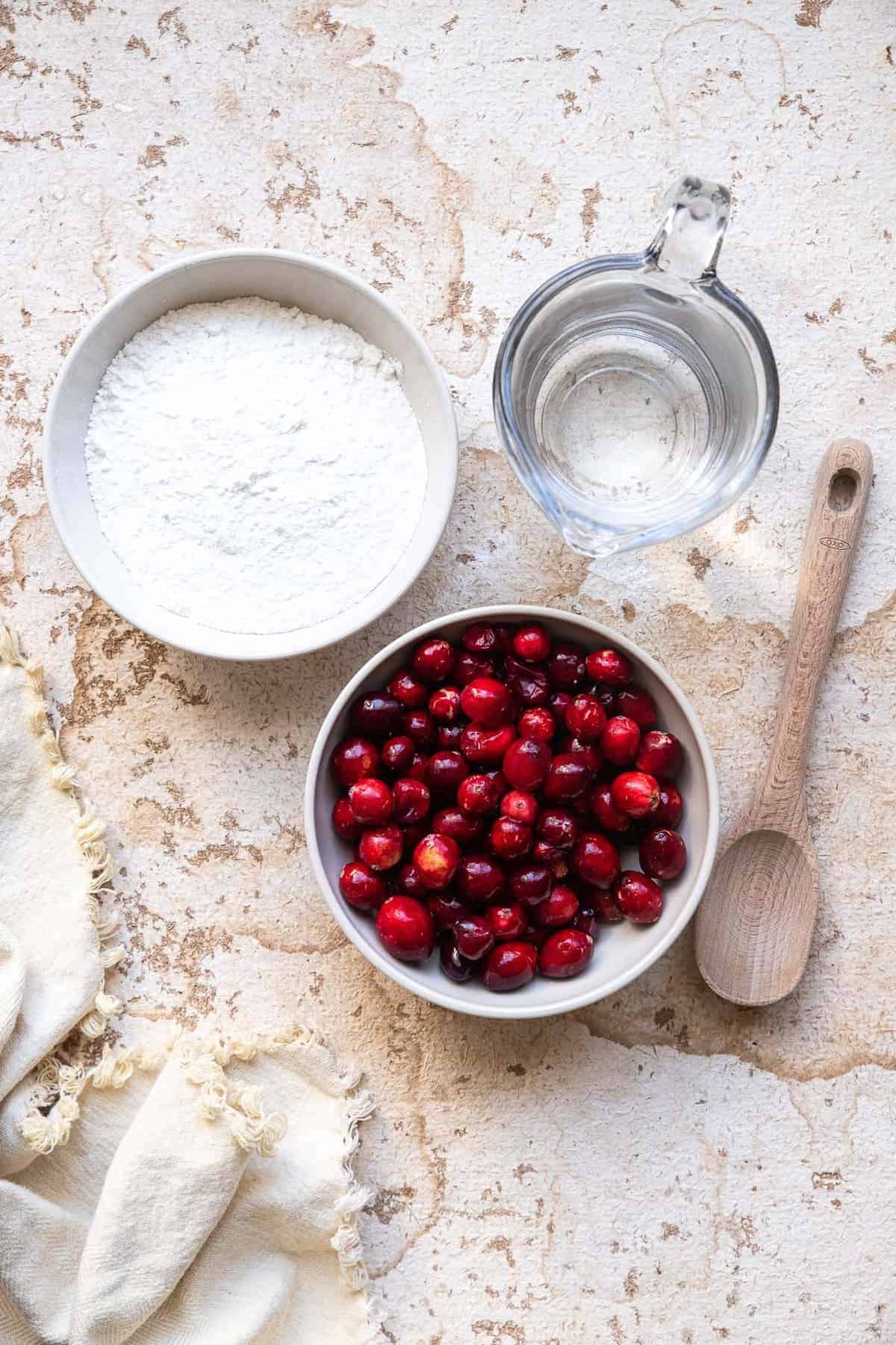 Low Carb Sugar Free Keto Cranberry Sauce - this Keto Cranberry Sauce is only 3 ingredients and SO easy to make! It's better than store bought, naturally gluten free and healthy! | #Foodfaithfitness | #glutenfree #paleo #keto #sugarfree #lowcarb ingredients to make low carb keto cranberry sauce in bowls