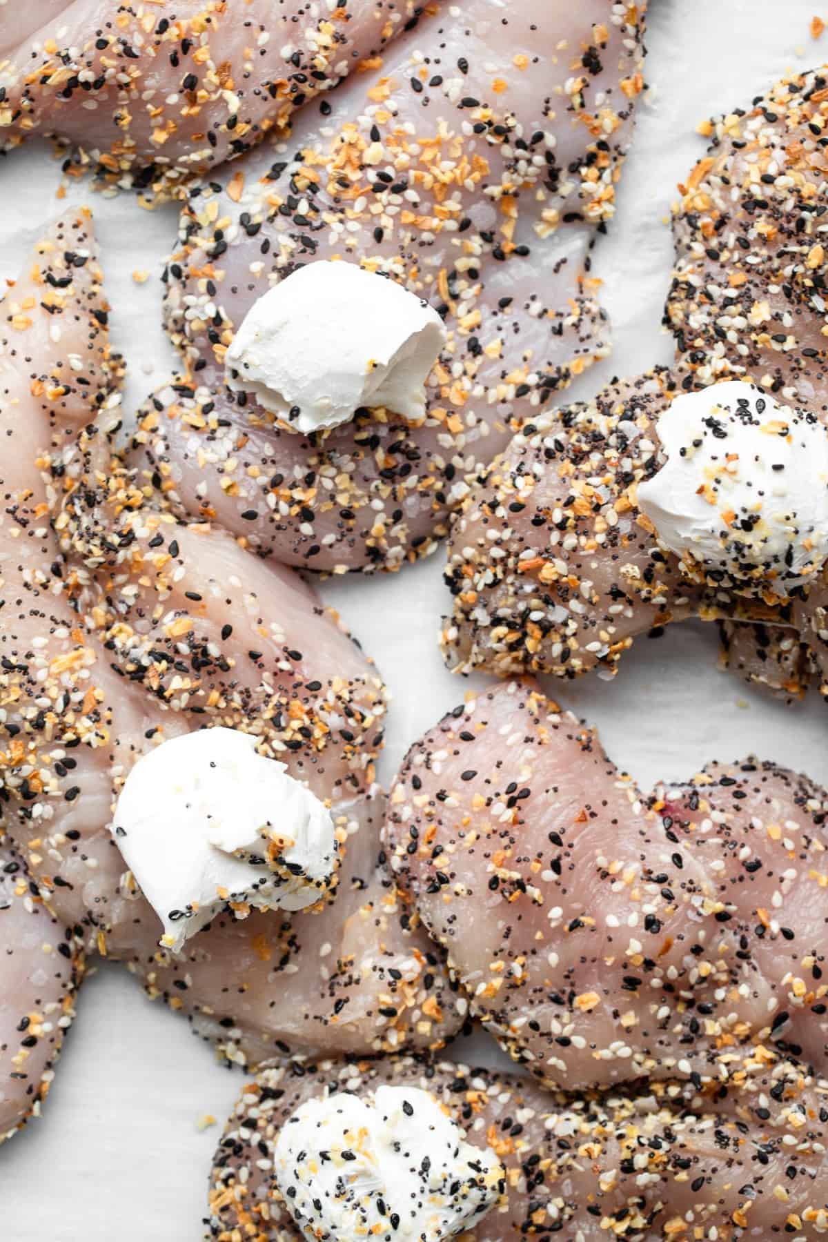 Everything Bagel Chicken - This Everything Bagel Chicken is stuffed with cream cheese for an easy, 4 ingredient meal that will please even picky eaters! Naturally gluten free, keto, low carb and delicious! | #Foodfaithfitness | #glutenfree #lowcarb #keto #healthy everything chicken butterflied on a counter