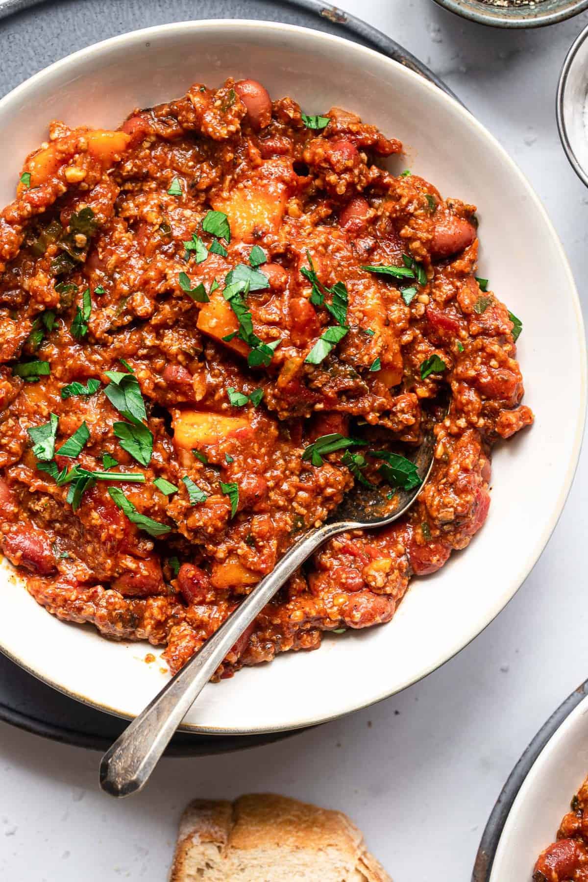 Ground Turkey sweet potato chili on food faith fitness a bowl of turkey sweet potato chili with cilantro on top