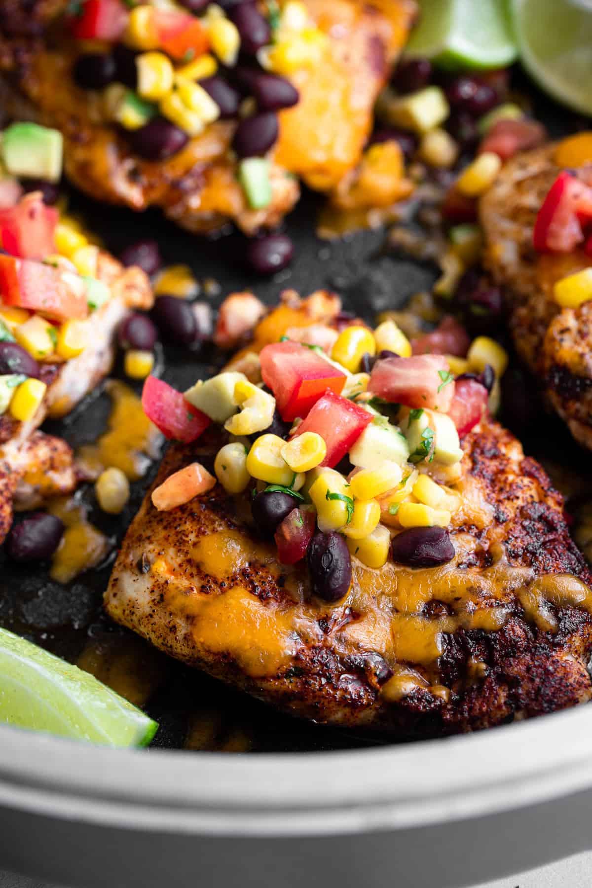 Santa Fe Chicken - This Santa Fe Chicken is an easy, weeknight dinner that is naturally gluten free and healthy! This will please even the pickiest of eaters! | #Foodfaithfitness | #glutenfree #healthy #dinner #chickendinner #kidfriendly Mexican chicken in a skillet covered with cheese