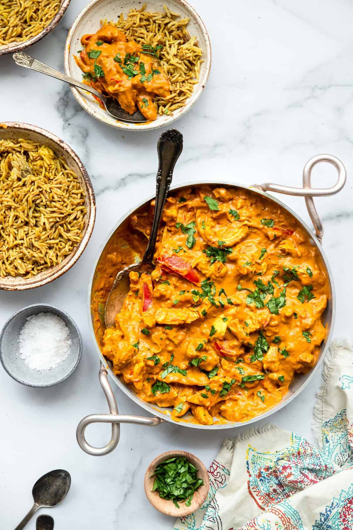 Whole30 Coconut Paleo Chicken Curry - This low carb Curry is an easy weeknight dinner with bold, Indian flavor. Simple to make, great for meal prep and low carb, keto and whole30 friendly too! | #Foodfaithfitness | #Glutenfree #Paleo #whole30 #lowcarb #keto paleo curry in an Indian serving bowl with rice on the side
